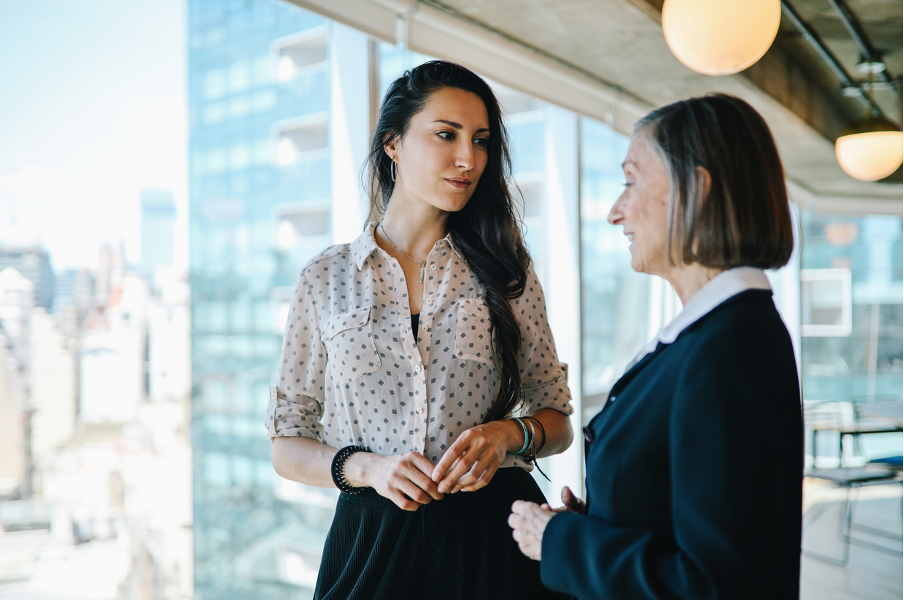 Confidential conversation between colleagues of different generations about menopause support at work